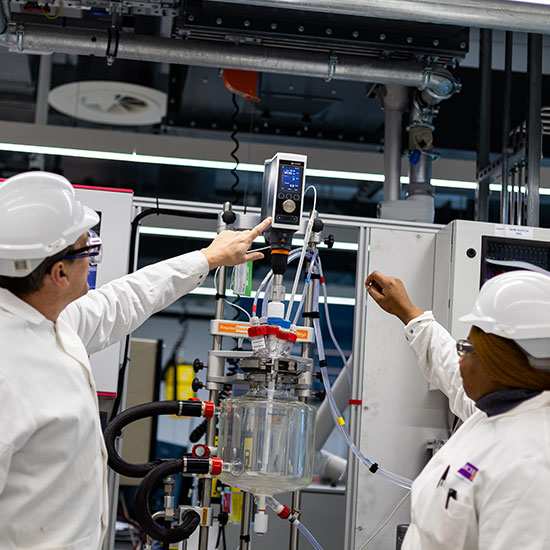 Researchers using laboratory equipment during hands-on scientific training.